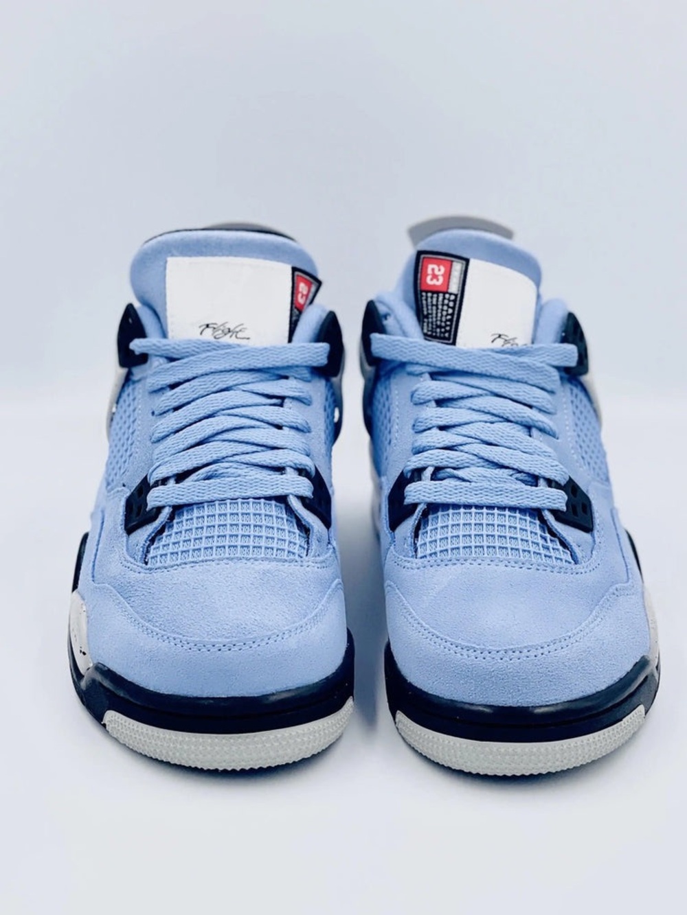Size 10 - Jordan 4 Retro Mid University Blue Black White Suede sneakers.